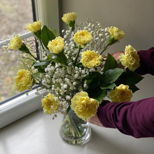 Yellow carnation with other flower 