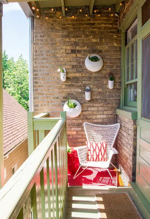 A Small White Chair on a Narrow Balcony