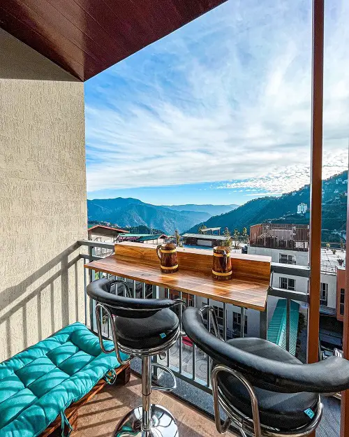 Railing Mounted Wooden Shelf with Movable Chairs in balcony