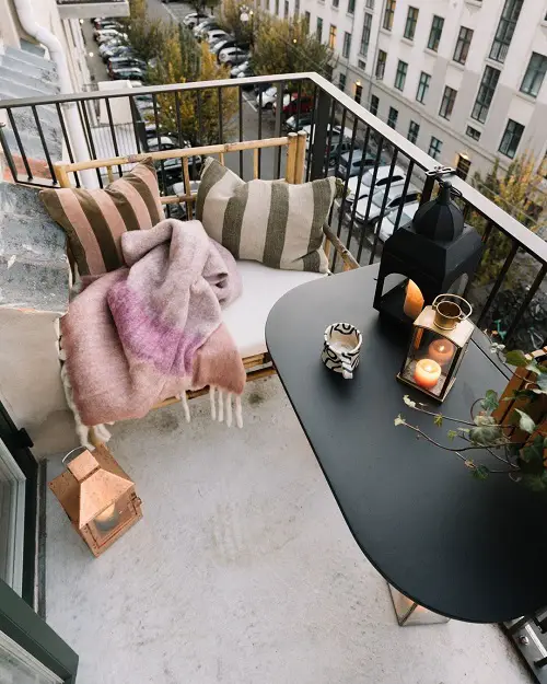 A Corner Cane Couch on a Balcony with a Lane View