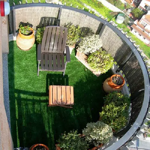 Turfy Floor with Potted Plants along the Railing