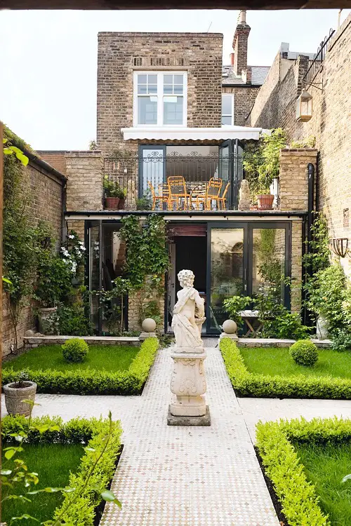 Garden with a Statue and Bright Grass