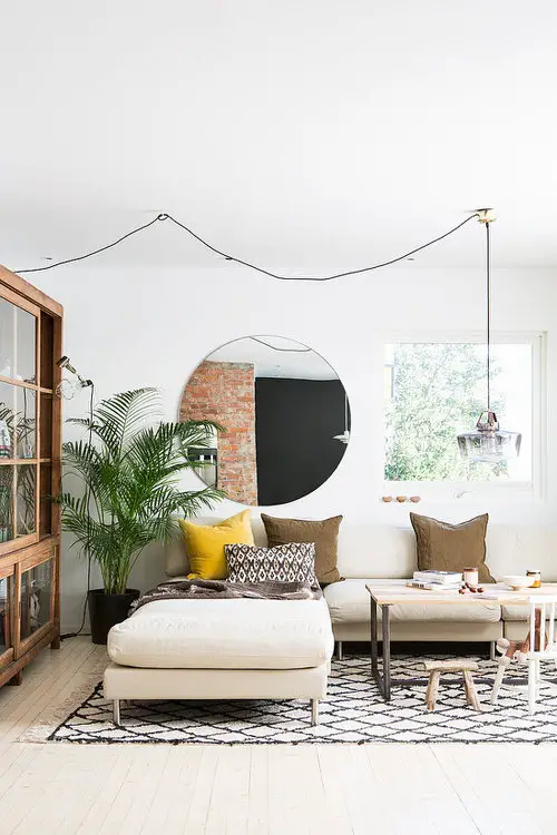 Retro Themed Room with Large Mirror and Palm