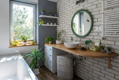 Exposed Brick Wall, Round Mirror, and Potted Plants!