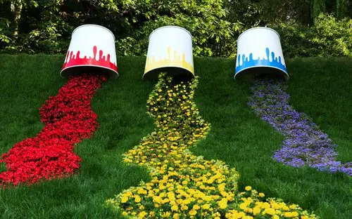 Old Paint Tin Cans with Spilling Flowers