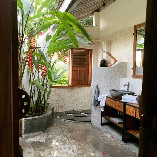 An Outdoor Shower with a Tropical Setting
