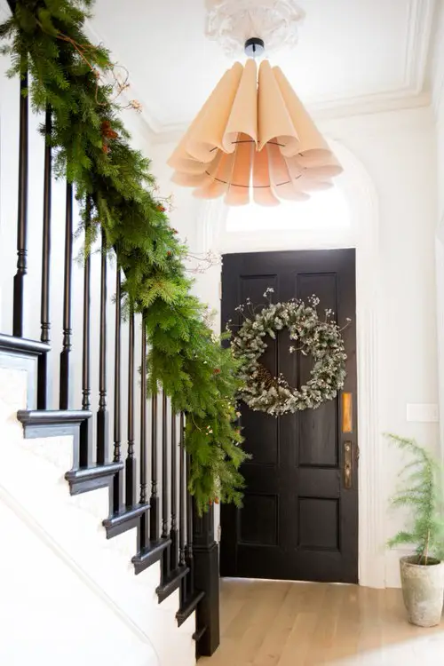 A Green Entry Staircase with Potted Plant