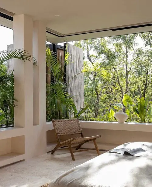 Bedroom with a Large Window Outlooking Greenery