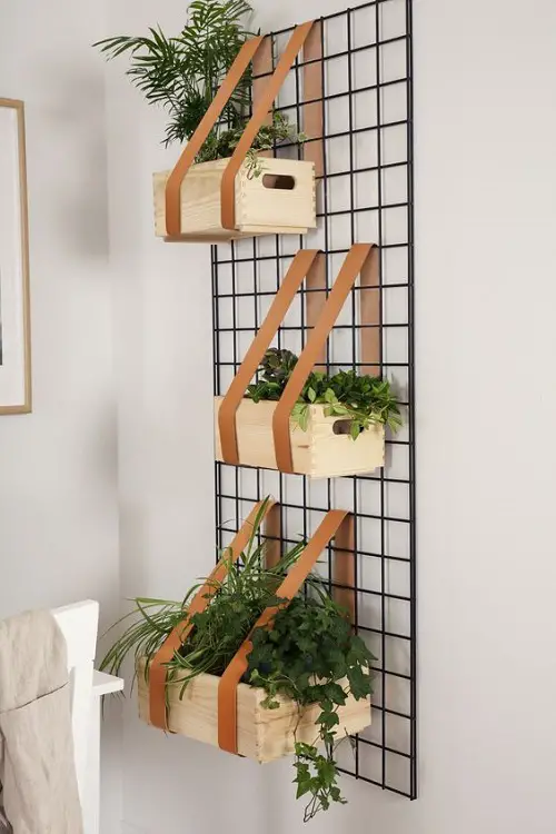 A Metal Wall Mesh will Hold Herb Planters in Style