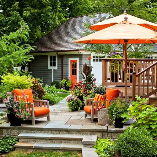 Front Yard Landscaping with Orange Umbrellas and Couch