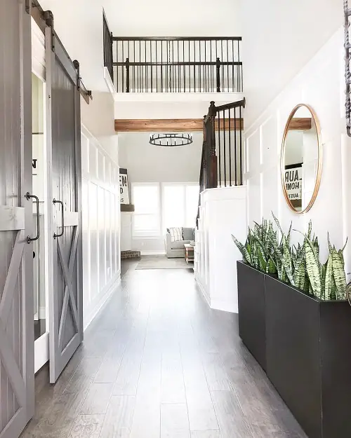 Matte Black Plant Boxes Under a Round Mirror