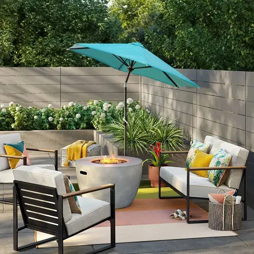 Beautiful Torquoise Umbrella beside a Firepit