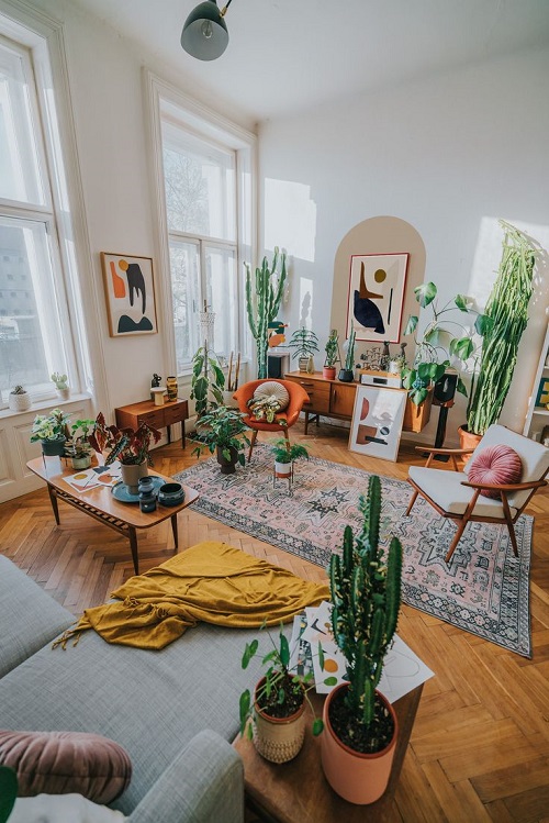 A Large Room with Tall Windows and Multiple Plants