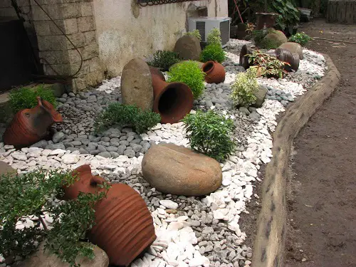 Outdoor Rock Garden with Pots, Boulders, and Border Plants