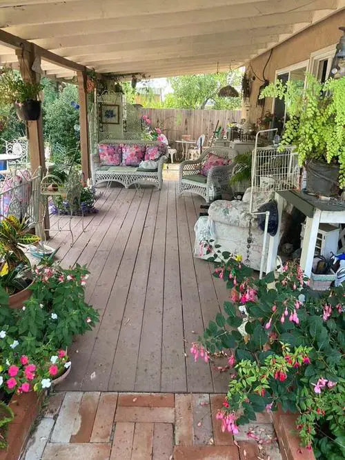 Front Gallery with Fuchsia Blooms and Potted Plants