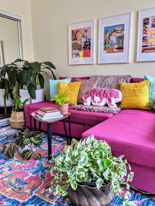 Paintings, Couch, and Potted Variegated Plants