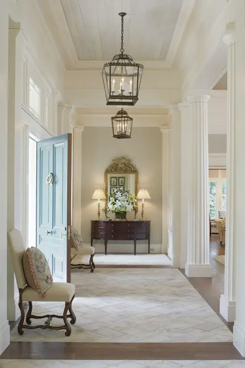 Intricate Pendant Lights in High Collumnar Hallway