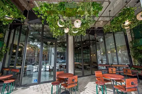 Green Ceiling with Hanging Lights Decking a Lavish Sit Out
