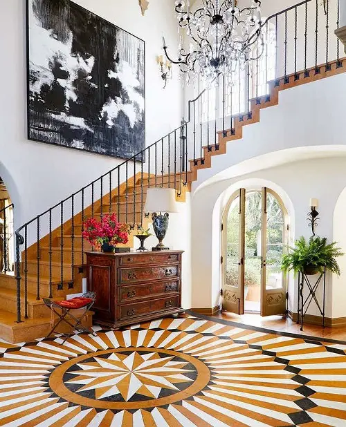 Spanish Foyer Decor with Terracotta Hues and Wrought Iron Railings