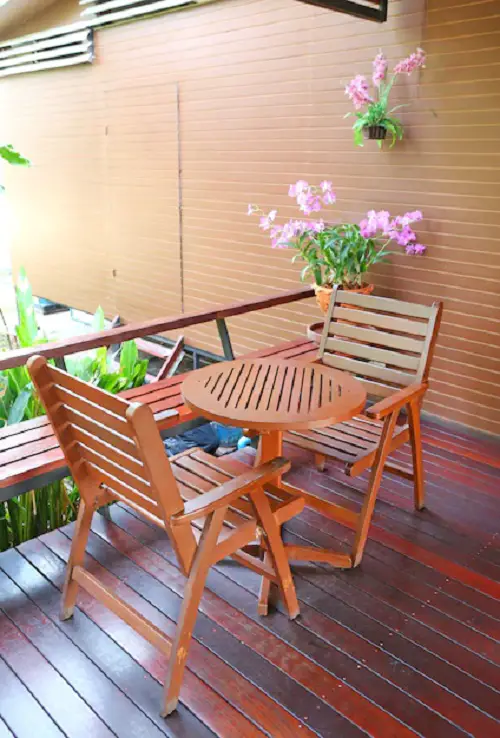 A Pair of Wooden Chairs, a Round Table, and a Wooden Bench