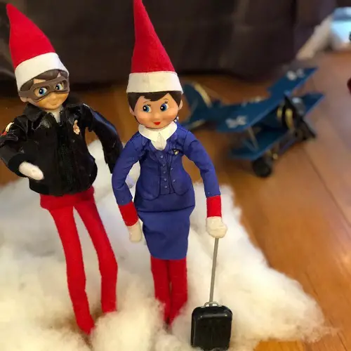 Elf Showeling the Snow on the Shelf