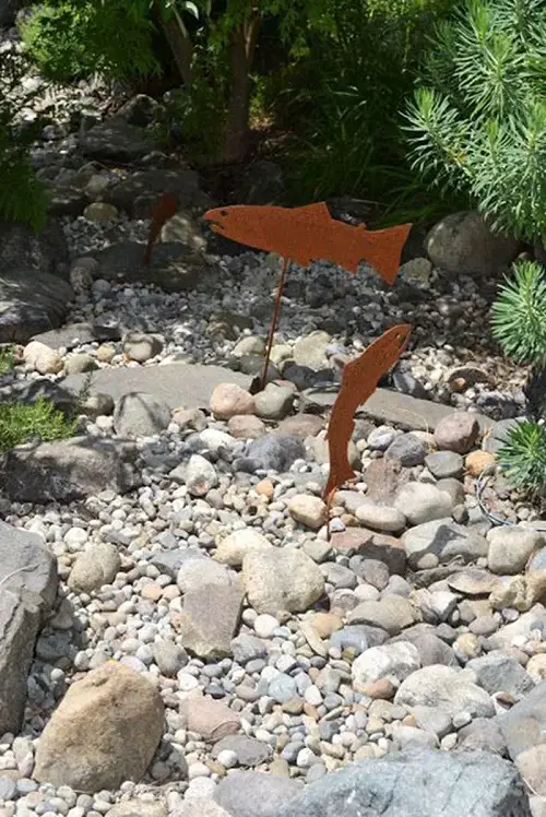 Metal Fish Signs in dry river