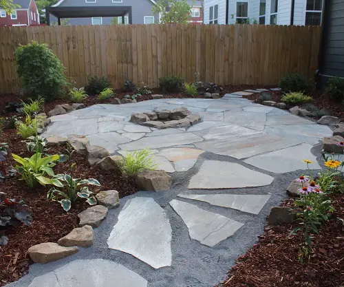 Flagstone Backyard Patio with Wooden Fence