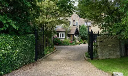 Gravel Driveway with Metal Gate Entrance