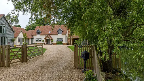 Curvy Driveway with Wooden Fence