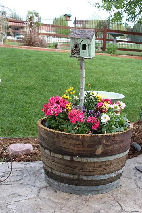 Whiskey Barrel Planter with Inserted Bird House