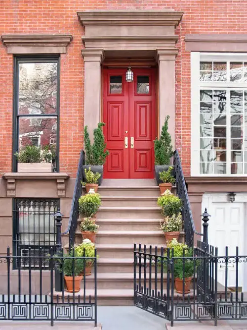 Bright Red Door With Plants Aligned Vertically