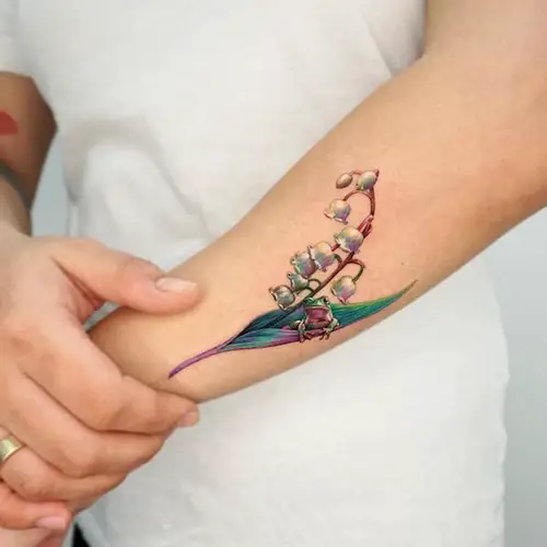 Realistic Lily of the Valley tattoo