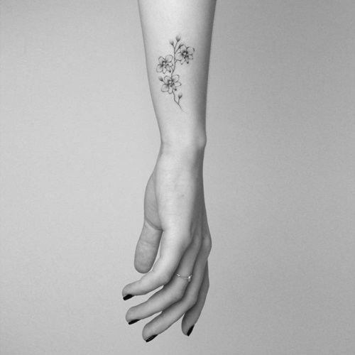 Small Orchids on the Wrist tattoo