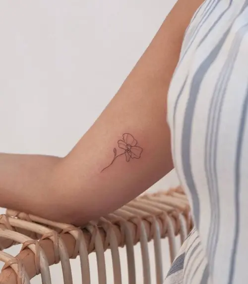 Orchid Outline on Bicep tattoo