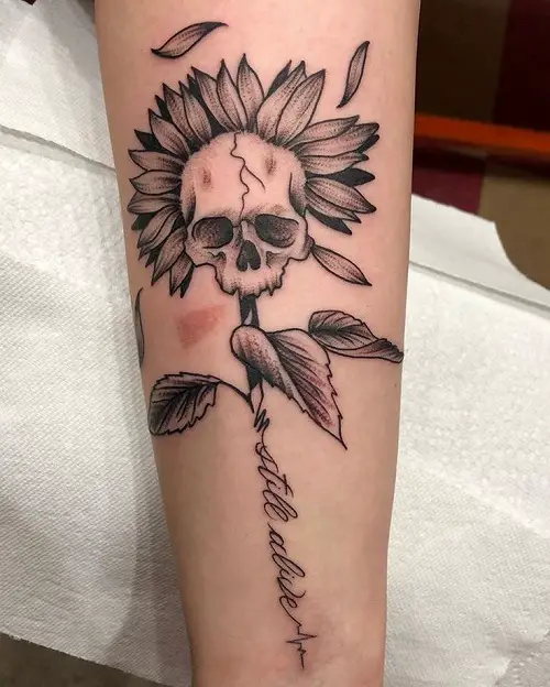 Skull with Withering Sunflower and “Still Alive” Quote tattoo