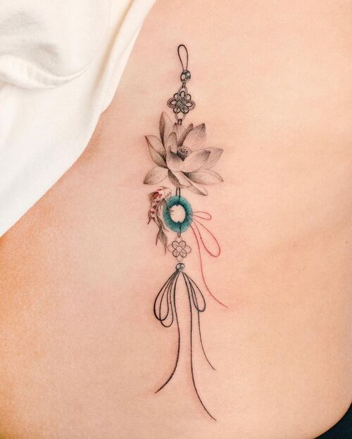 Lotus, Koi Fish, and Jade Ring Charm Tattoo