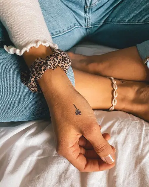 Tiny Palm Tree on the Thumb tattoo
