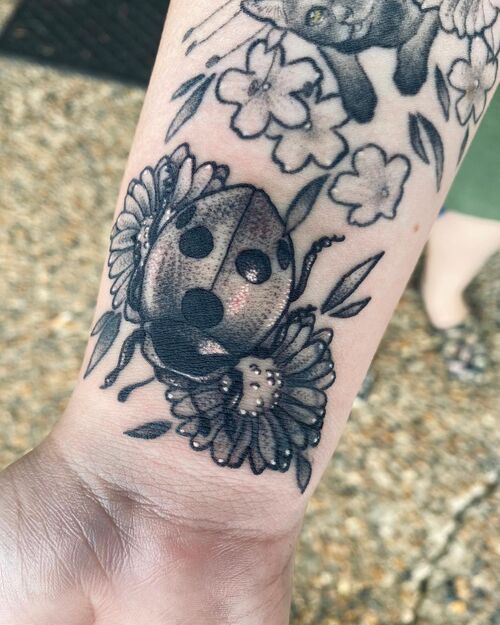 Black and Gray Ladybug on Flowers Tattoo