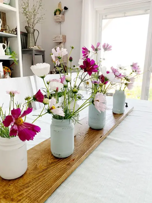 Cosmos in painted recycled cooking jars